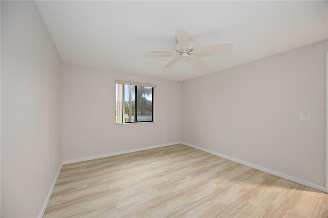 empty room with ceiling fan and light hardwood / wood-style floors