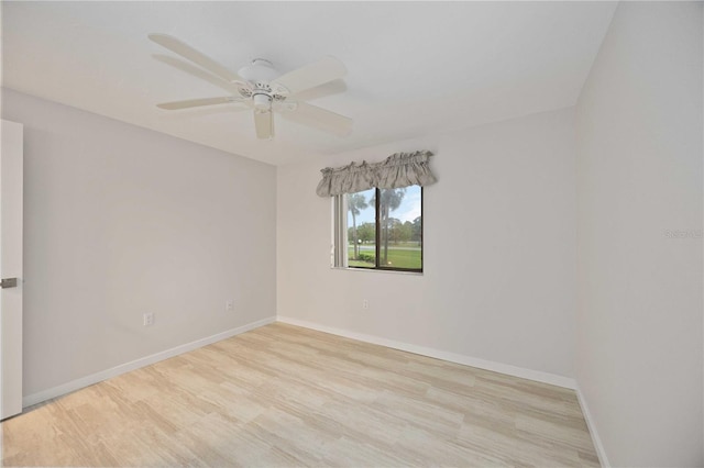 empty room with ceiling fan and light hardwood / wood-style floors