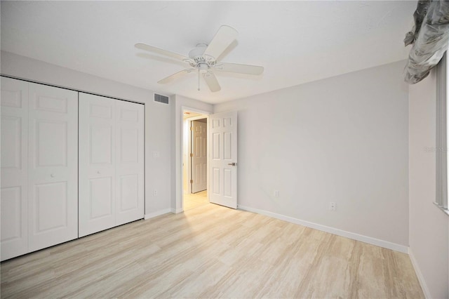 unfurnished bedroom with ceiling fan, light hardwood / wood-style floors, and a closet