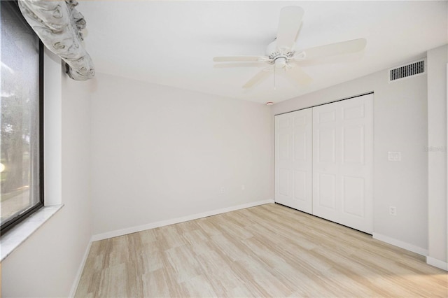 unfurnished bedroom featuring ceiling fan, a closet, and light hardwood / wood-style floors