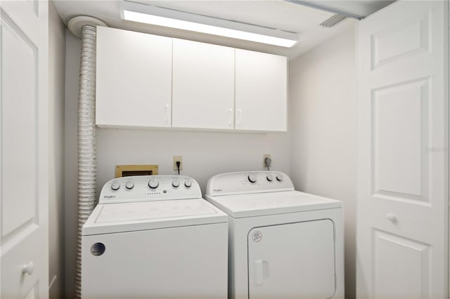 laundry area featuring cabinets and independent washer and dryer