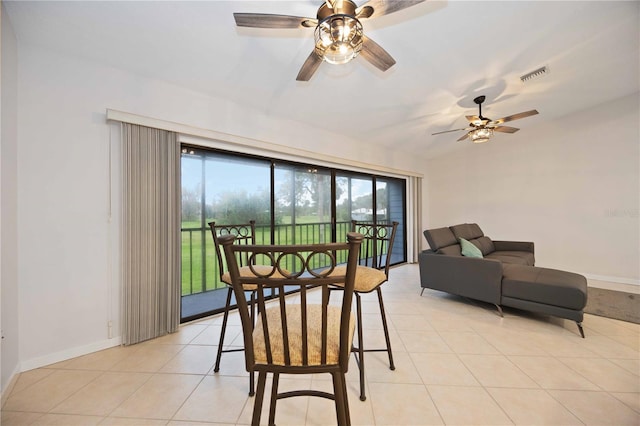 dining space with light tile patterned floors and ceiling fan