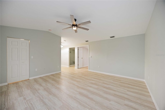 empty room with light hardwood / wood-style floors, ceiling fan, and lofted ceiling