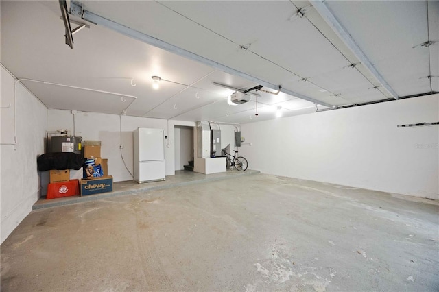 garage featuring white fridge and a garage door opener