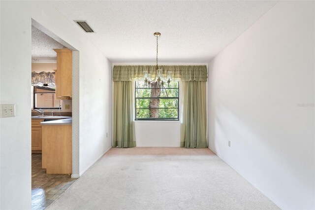 2807 Country River Dr, Parrish, FL 34219 - unfurnished dining area with a textured ceiling, a chandelier, and light colored carpet