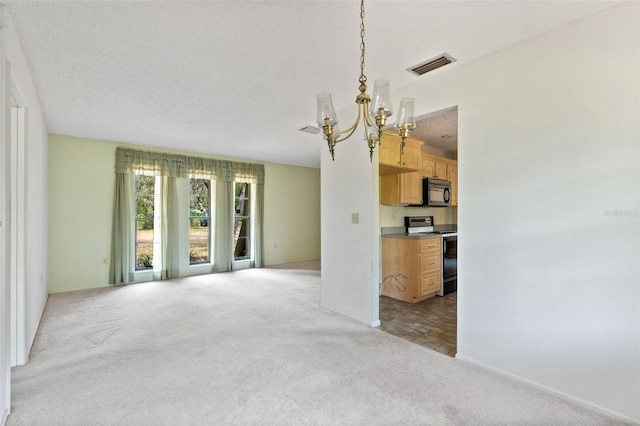 unfurnished living room with light carpet, a textured ceiling, and an inviting chandelier