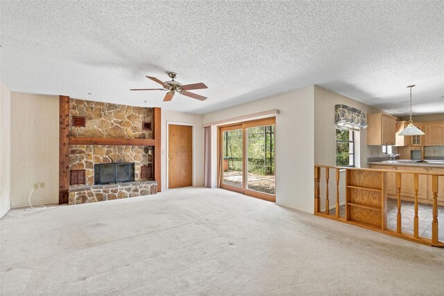 2807 Country River Dr, Parrish, FL 34219 - unfurnished living room featuring ceiling fan, carpet floors, a textured ceiling, and a fireplace