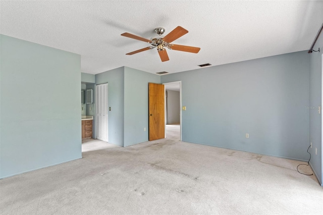 2807 Country River Dr, Parrish, FL 34219 - unfurnished bedroom featuring carpet, a ceiling fan, ensuite bath, and a textured ceiling