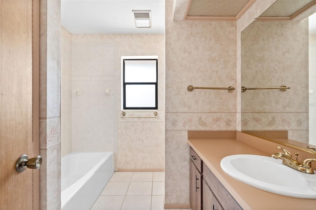 bathroom featuring tile patterned flooring, a bathtub, and vanity