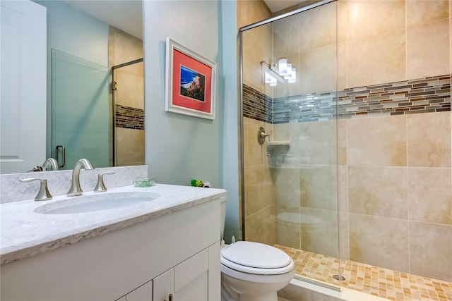 bathroom with an enclosed shower, vanity, and toilet