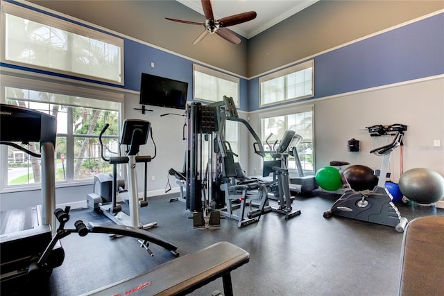 gym with ceiling fan and ornamental molding