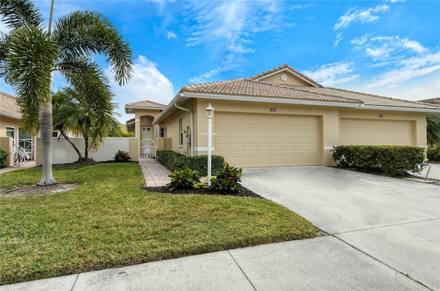 view of front of house featuring a garage and a front lawn