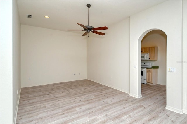 unfurnished room with ceiling fan and light hardwood / wood-style flooring