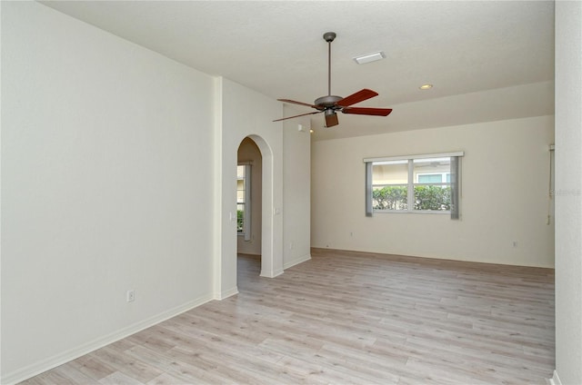 spare room with ceiling fan, light wood-type flooring, and a textured ceiling