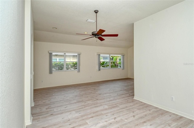 spare room featuring ceiling fan, light hardwood / wood-style floors, and a textured ceiling