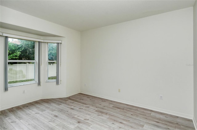 empty room with light hardwood / wood-style flooring