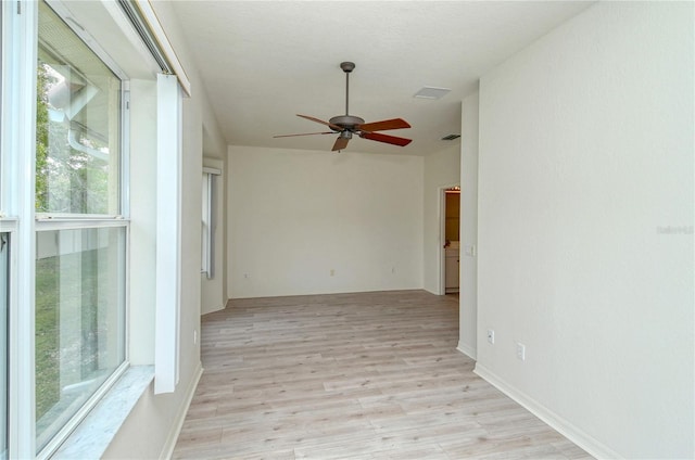 unfurnished room with light wood-type flooring and ceiling fan