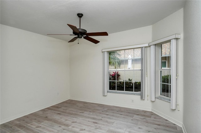 empty room featuring ceiling fan, light hardwood / wood-style floors, and a textured ceiling