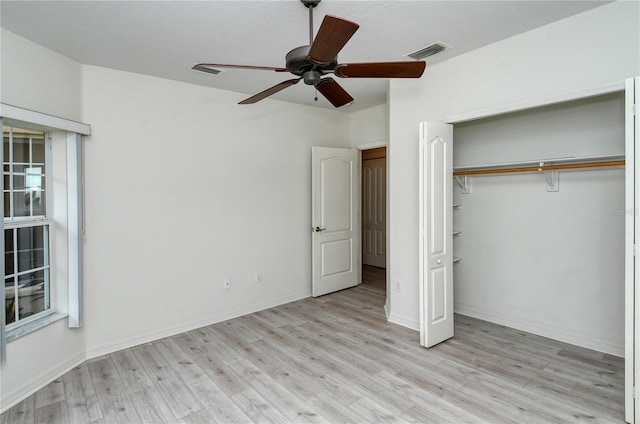 unfurnished bedroom with ceiling fan, light hardwood / wood-style floors, and a closet