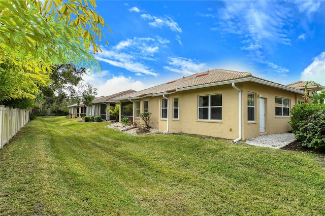 rear view of property with a yard