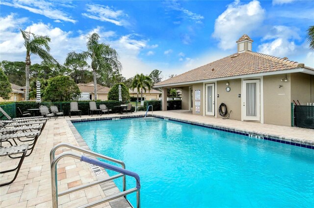 view of swimming pool with a patio