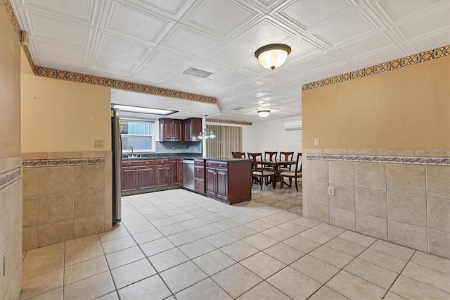 kitchen featuring dishwasher, sink, and light tile patterned floors