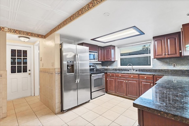 kitchen featuring sink, light tile patterned floors, and appliances with stainless steel finishes