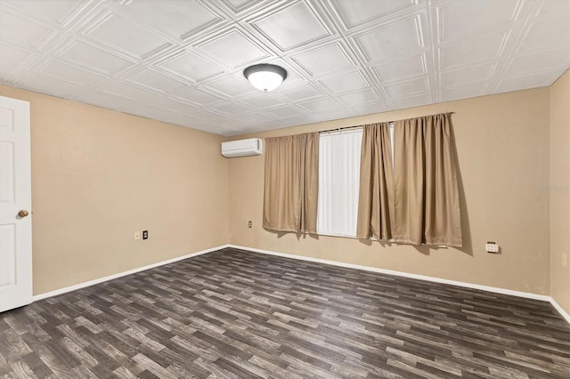 spare room featuring an AC wall unit and dark wood-type flooring