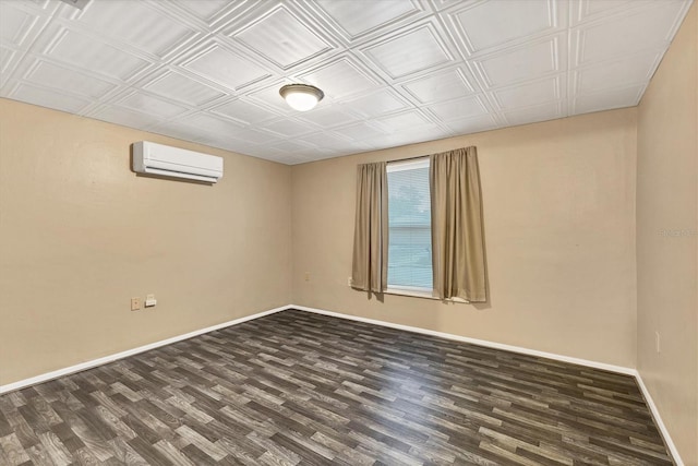 spare room featuring an AC wall unit and dark wood-type flooring