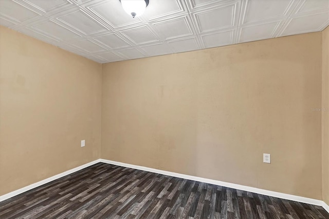 empty room with dark hardwood / wood-style flooring