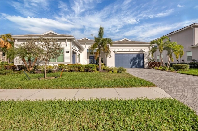 view of front of property with a front yard and a garage