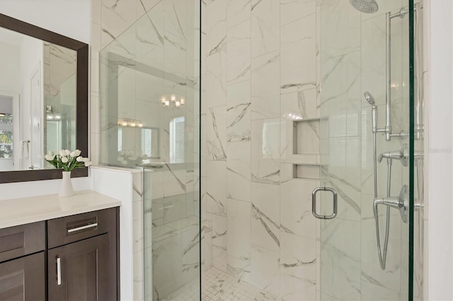 bathroom featuring vanity and an enclosed shower