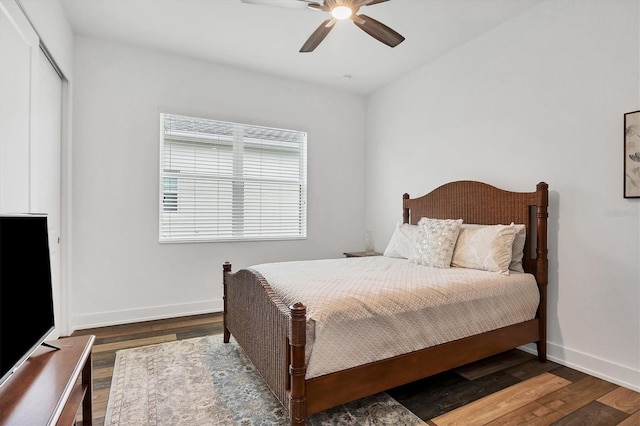 bedroom featuring dark hardwood / wood-style flooring, a closet, and ceiling fan