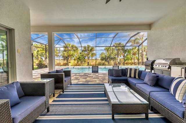 view of patio / terrace with a lanai, outdoor lounge area, a grill, and exterior kitchen