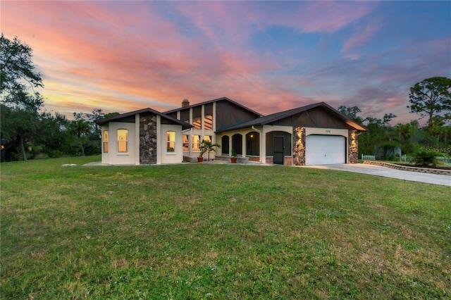 view of front of house with a garage and a yard