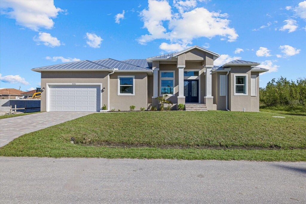 view of front facade with a front lawn and a garage