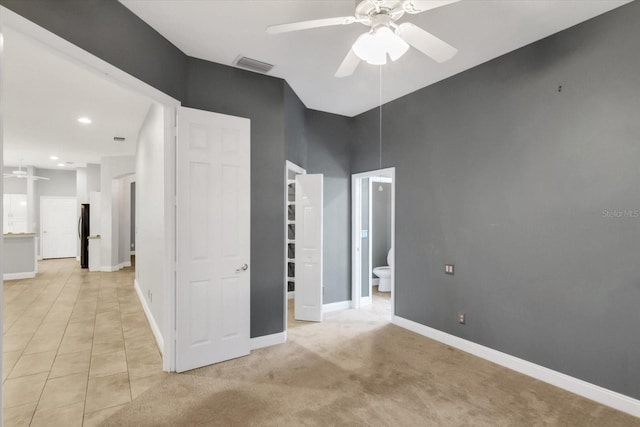 carpeted spare room with ceiling fan