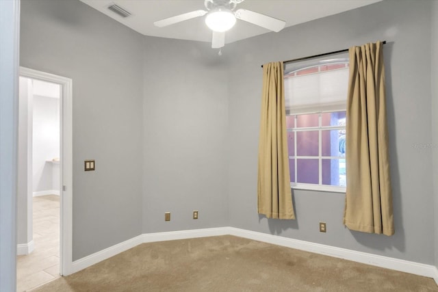 carpeted spare room featuring ceiling fan