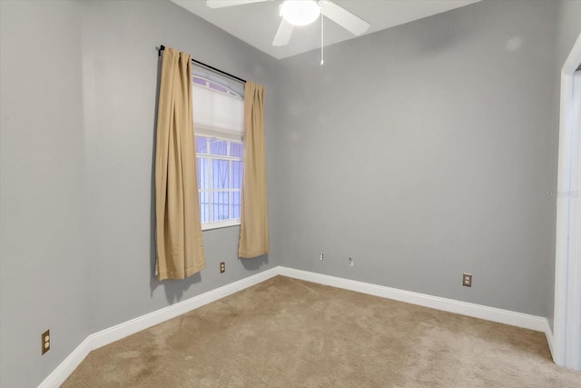 spare room with light carpet and ceiling fan