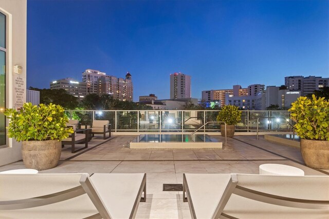 1335 2nd St Unit 301, Sarasota, FL 34236 - patio at night with a view of city lights, outdoor lounge area, a patio, and a community pool