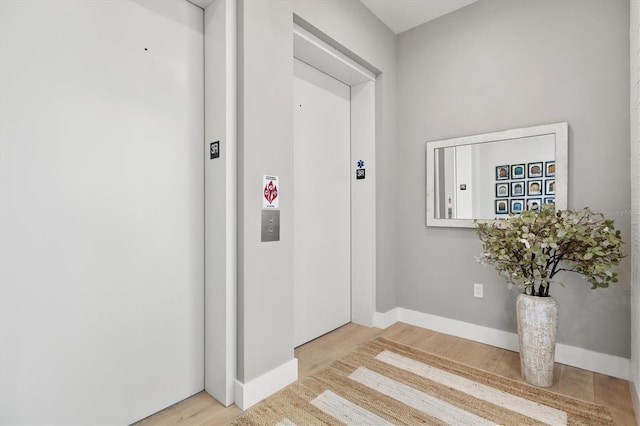 interior space featuring elevator and light hardwood / wood-style floors