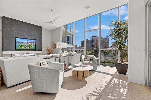 living room featuring light hardwood / wood-style floors and ceiling fan