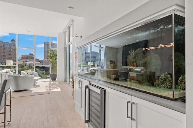 1335 2nd St Unit 301, Sarasota, FL 34236 - indoor bar featuring beverage cooler, a city view, light wood-style floors, and plenty of natural light
