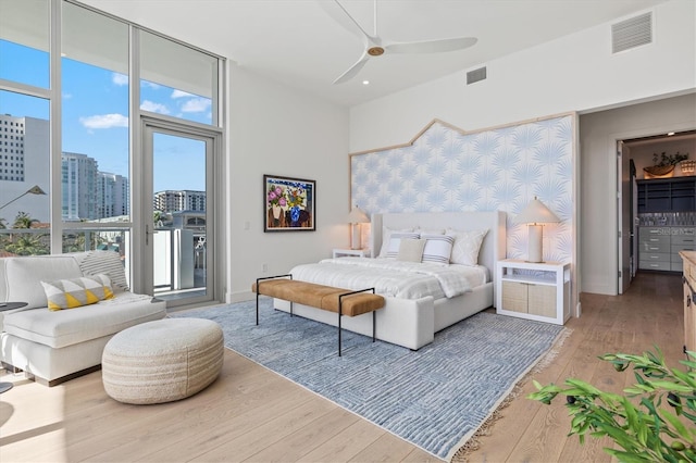 bedroom with ceiling fan, light hardwood / wood-style floors, and access to outside