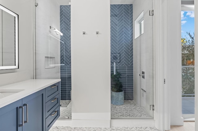 bathroom featuring tile patterned floors, vanity, and a shower with shower door