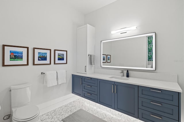 bathroom featuring tile patterned flooring, vanity, and toilet