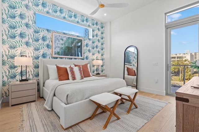 bedroom featuring access to outside, ceiling fan, and light wood-type flooring