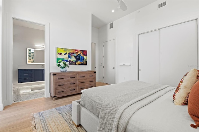 1335 2nd St Unit 301, Sarasota, FL 34236 - bedroom featuring light wood-type flooring, ensuite bathroom, a closet, and a ceiling fan