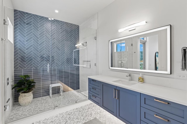 bathroom with tile patterned floors, a shower with door, and vanity