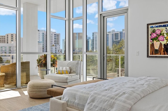 bedroom with hardwood / wood-style flooring and floor to ceiling windows